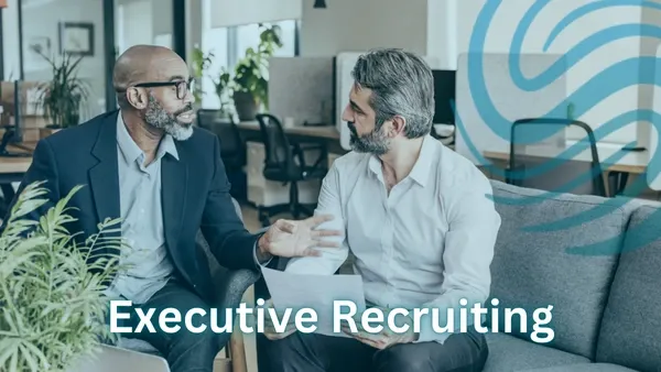 2 Professional Men who are conversing while sitting on a couch.  There is a Specialized Recruiting Group logo on top of the image.