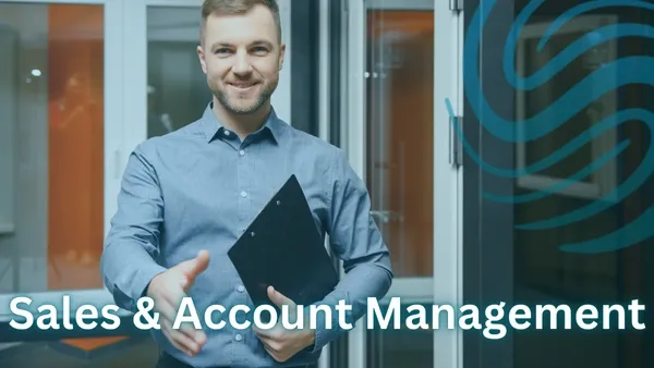  Man in a blue button up shirt holding a black clip board reaching out his right hand for a handshake in an office setting with the Specialized Recruiting Group Logo and the words Sales and Account Management written over the top of the image